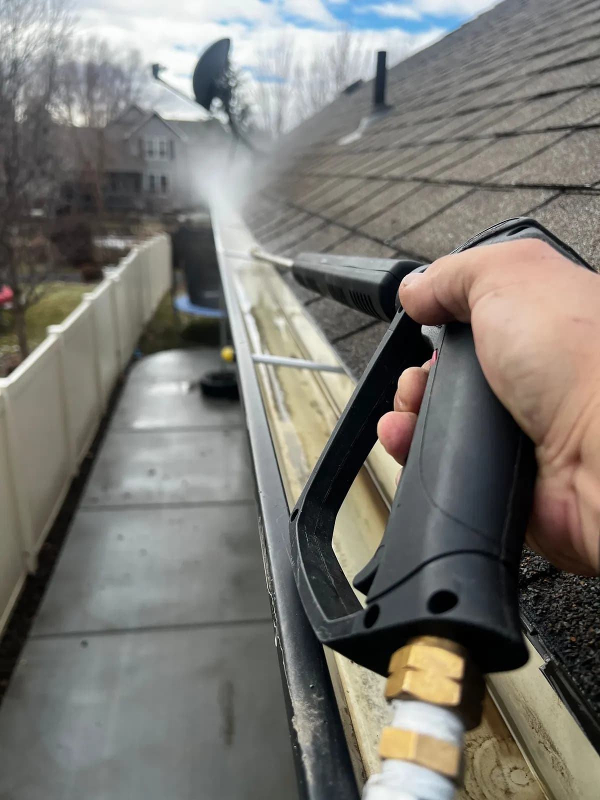 Gutter being cleared with a pressure jet